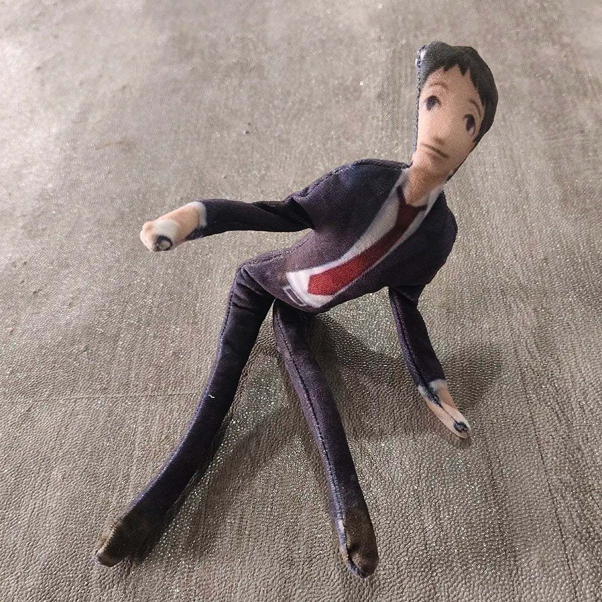 Toh Adachi stuffed toy against neutral background
