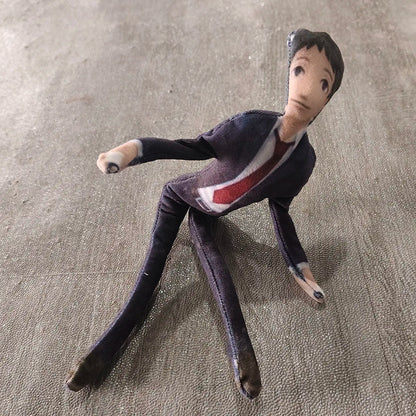 Toh Adachi stuffed toy against neutral background
