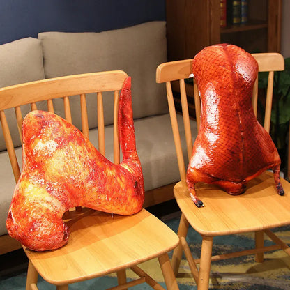 Two glossy roasted duck-shaped decorative objects displayed on wooden chairs in a living room setting.
