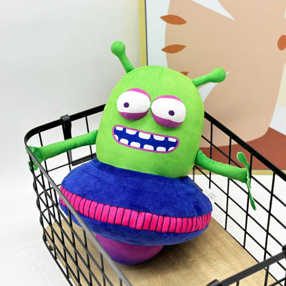 UFO alien plush toy displayed on gaming shelf next to controller