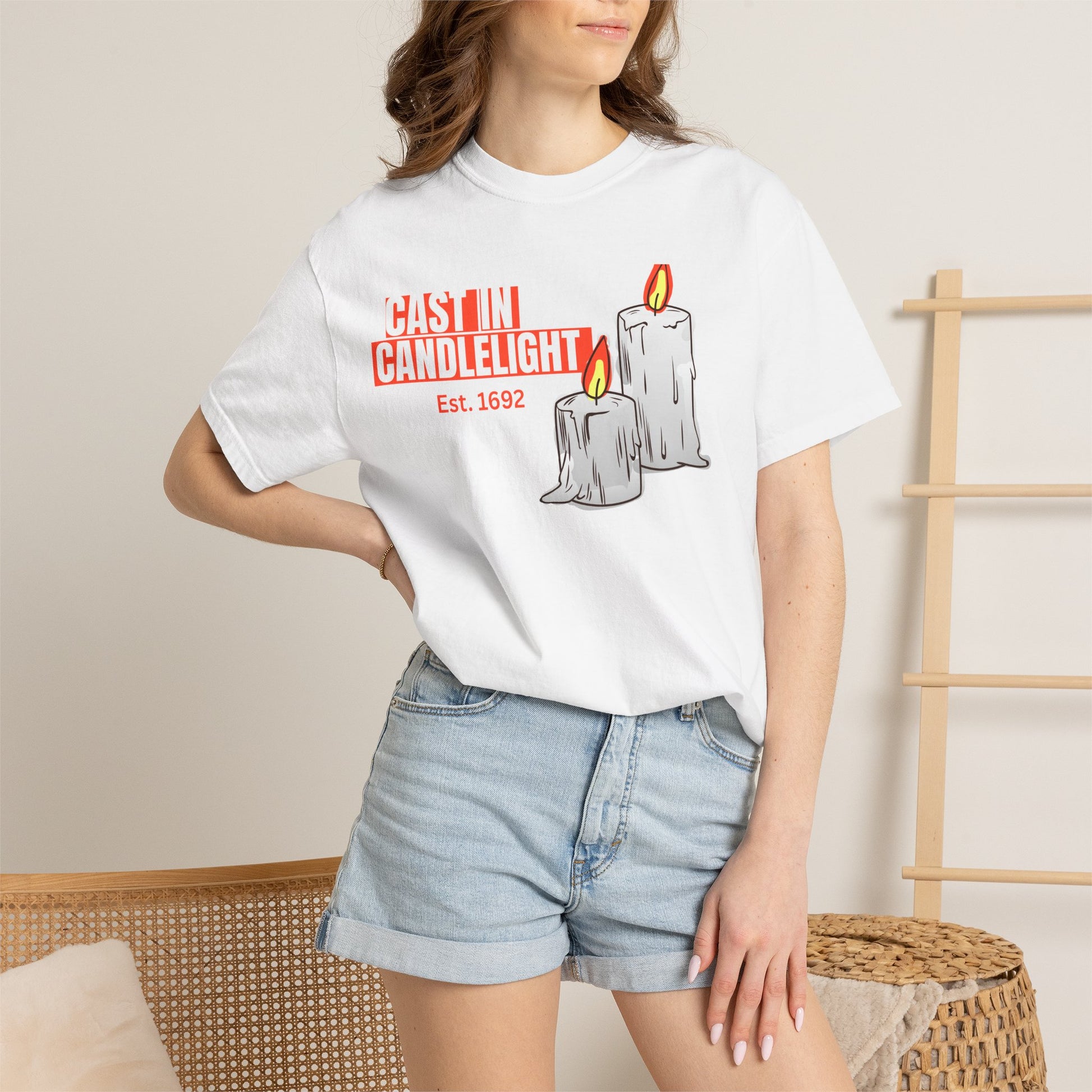 Unisex candle tee lifestyle flat lay with dried herbs, crystal cluster, and autumn leaves