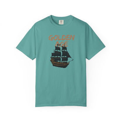 Unisex pirate ship graphic tee flat lay on a weathered wood surface
