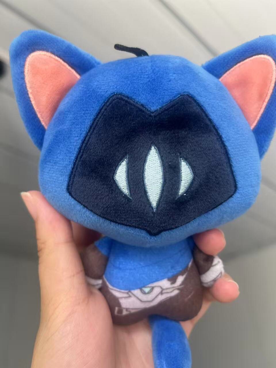 Valorant Omen toy sitting on gaming desk setup
