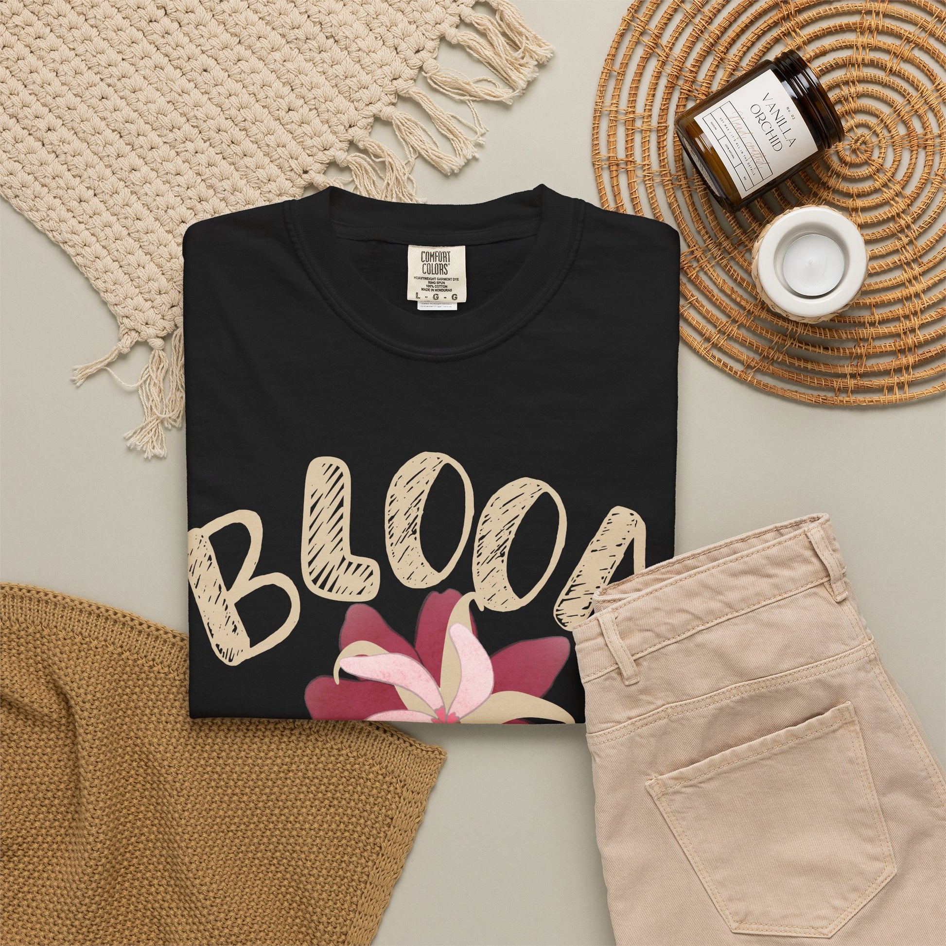 Vintage floral tee folded showing sun-washed garment-dye color depth and soft cotton texture