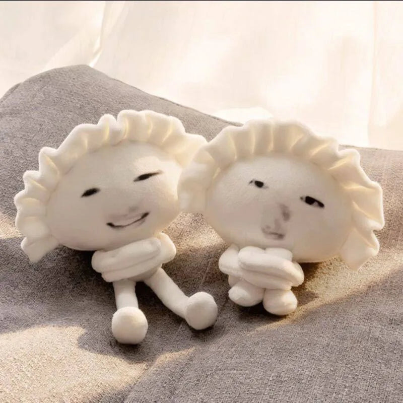 Viral meme plush gyoza pendant clipped to tote bag