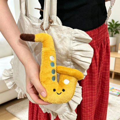 White 45cm kawaii saxophone plush on bed as throw plush decor