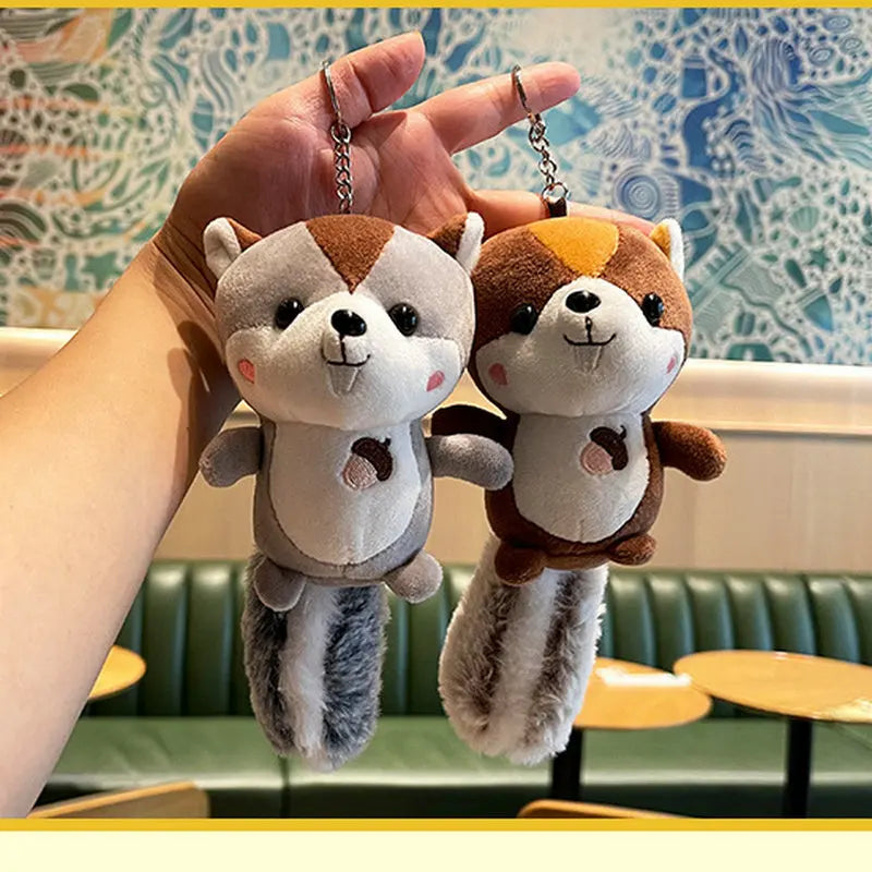 Woodland animal plush squirrel charm hanging from zipper pull on tote bag