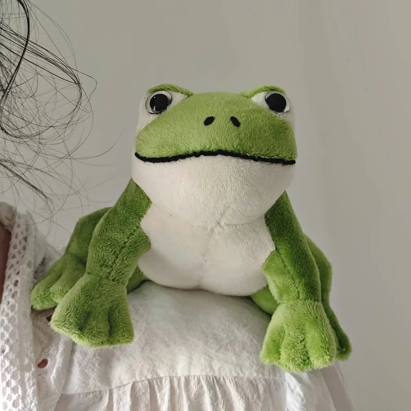 kawaii frog plushie perched on shirt collar lifestyle photo